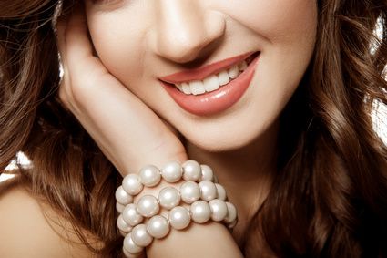 girl with a wide smile. Pearls
